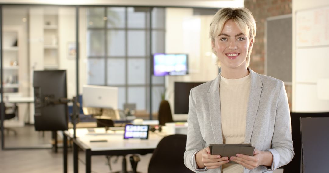 Young Professional Engaging with Tablet in Modern Workplace Environment