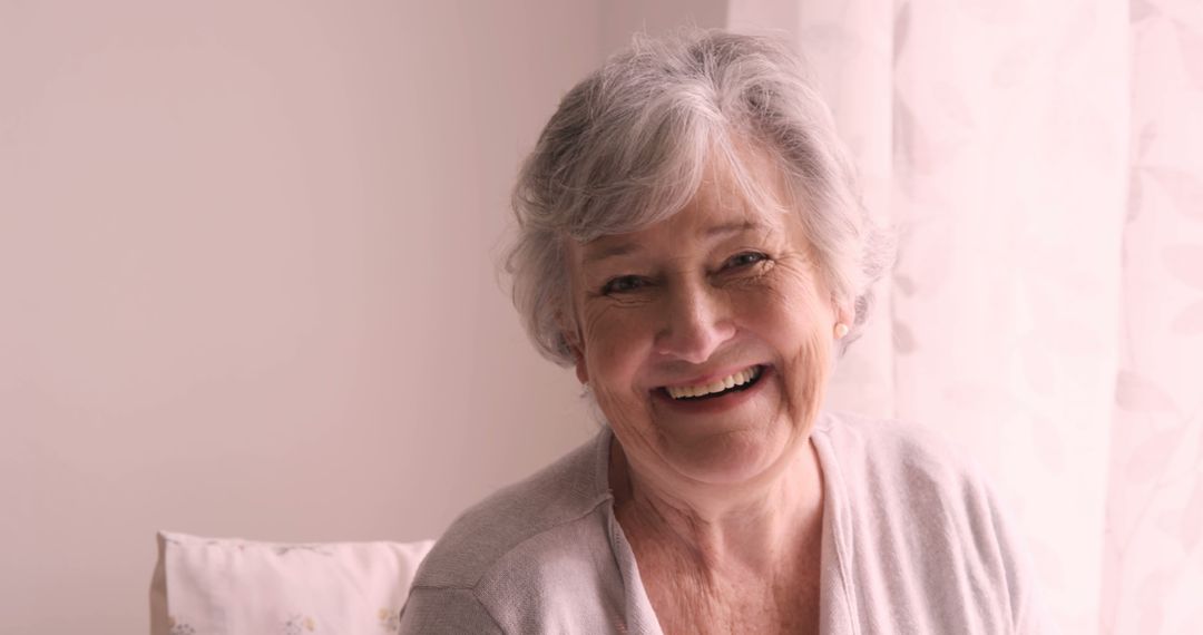 Smiling Senior Woman with Gray Hair in Cozy Home Setting - Free Images, Stock Photos and Pictures on Pikwizard.com