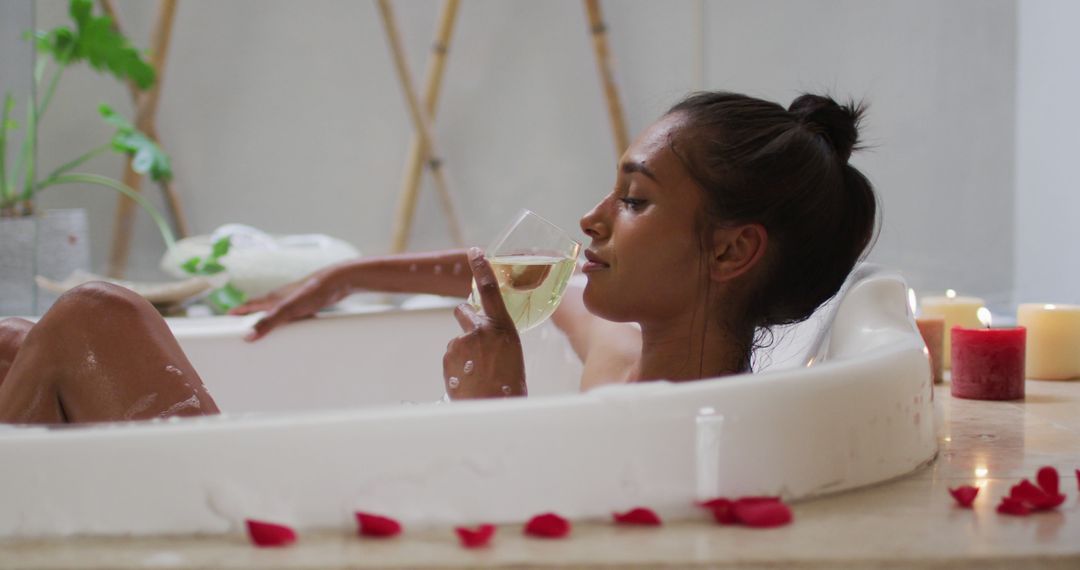 Woman Relaxing in Bathtub with Candlelight and Wine - Free Images, Stock Photos and Pictures on Pikwizard.com