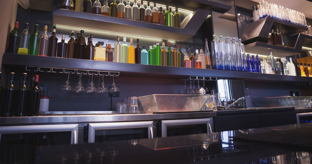 Modern Bar Interior with Assorted Bottles Displayed on Shelves