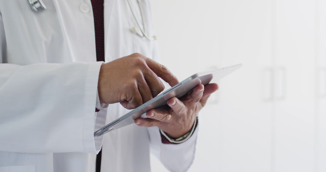 Doctor Using Digital Tablet in Medical Office - Free Images, Stock Photos and Pictures on Pikwizard.com