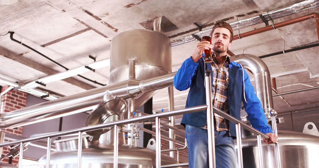 Brewery Worker Inspecting Beer Quality in Brewery Plant - Free Images, Stock Photos and Pictures on Pikwizard.com