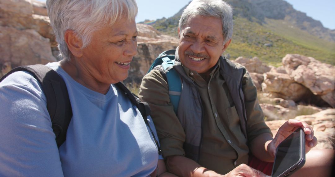 Senior Couple Hiking Outdoors and Using Digital Tablet - Free Images, Stock Photos and Pictures on Pikwizard.com