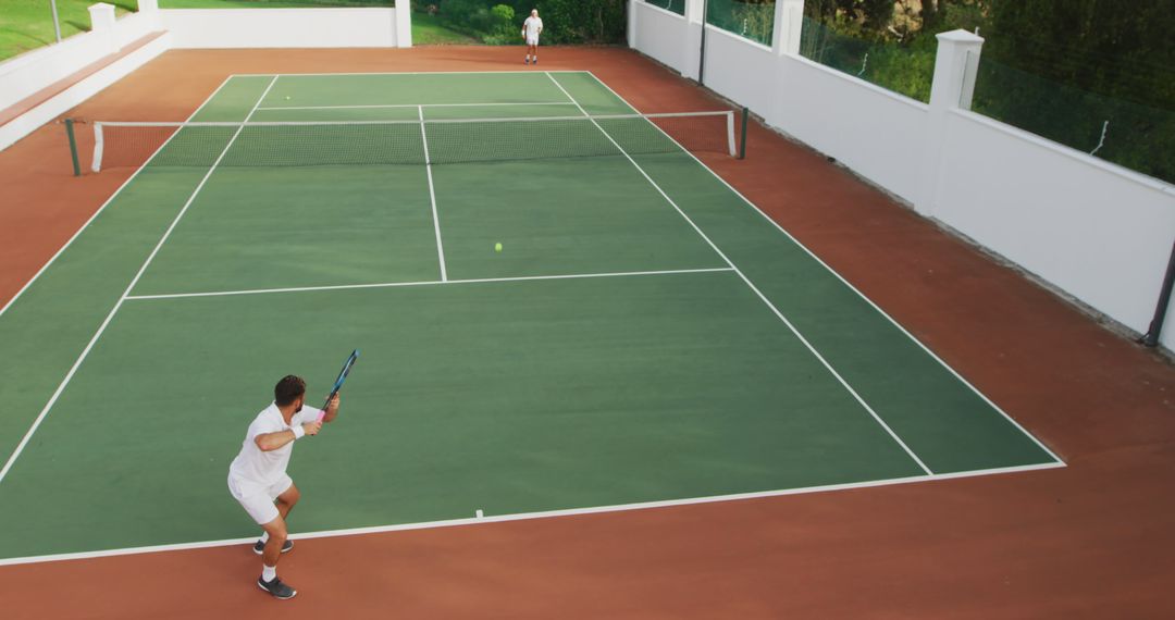 Tennis Players Competing in an Outdoor Tennis Court Match - Free Images, Stock Photos and Pictures on Pikwizard.com