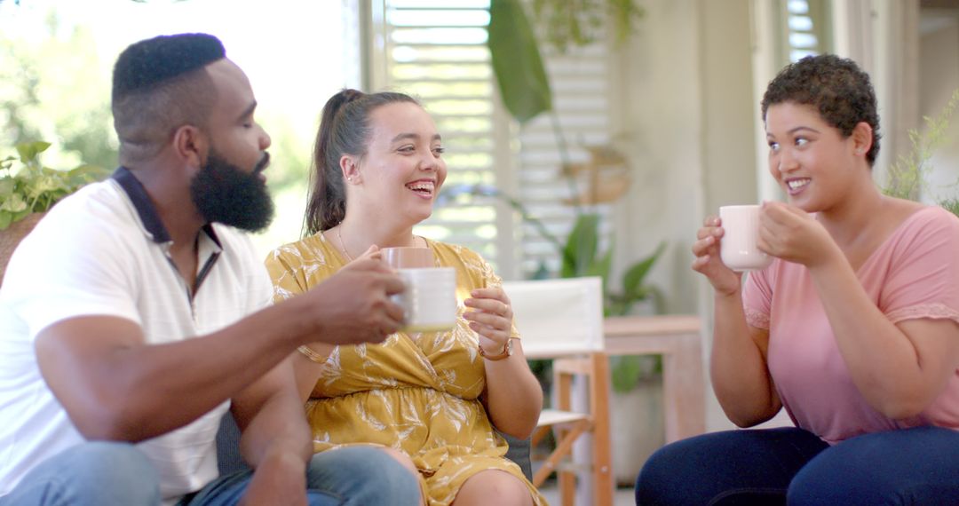 Friends Toasting with Coffee Mugs Celebrating Togetherness at Home