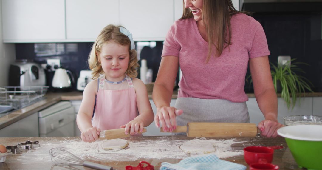 Mother and Daughter Enjoying Baking Time in Modern Kitchen