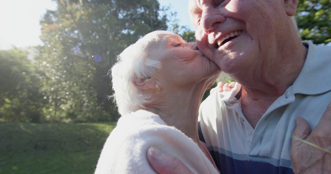 Joyful Senior Couple Embracing in Sunny Garden