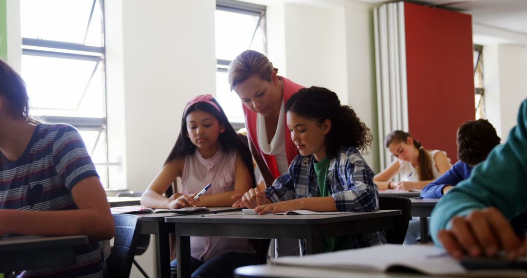 Female Teacher Helping Two Students in Classroom - Free Images, Stock Photos and Pictures on Pikwizard.com