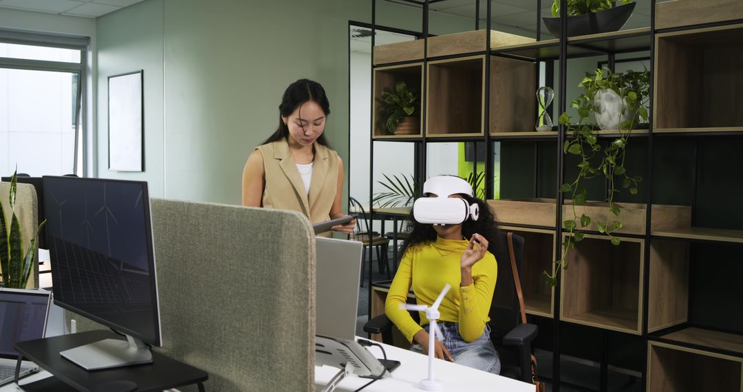 Coworkers Using VR Headset and Tablet in Innovative Green Office