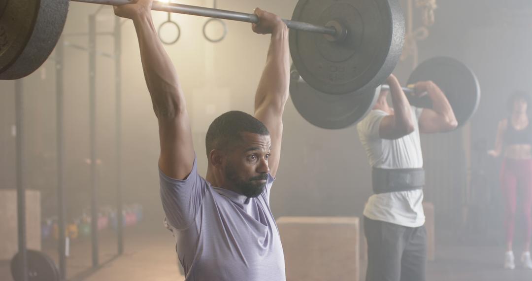 Dedicated Athlete Performing Overhead Press in Gym - Free Images, Stock Photos and Pictures on Pikwizard.com