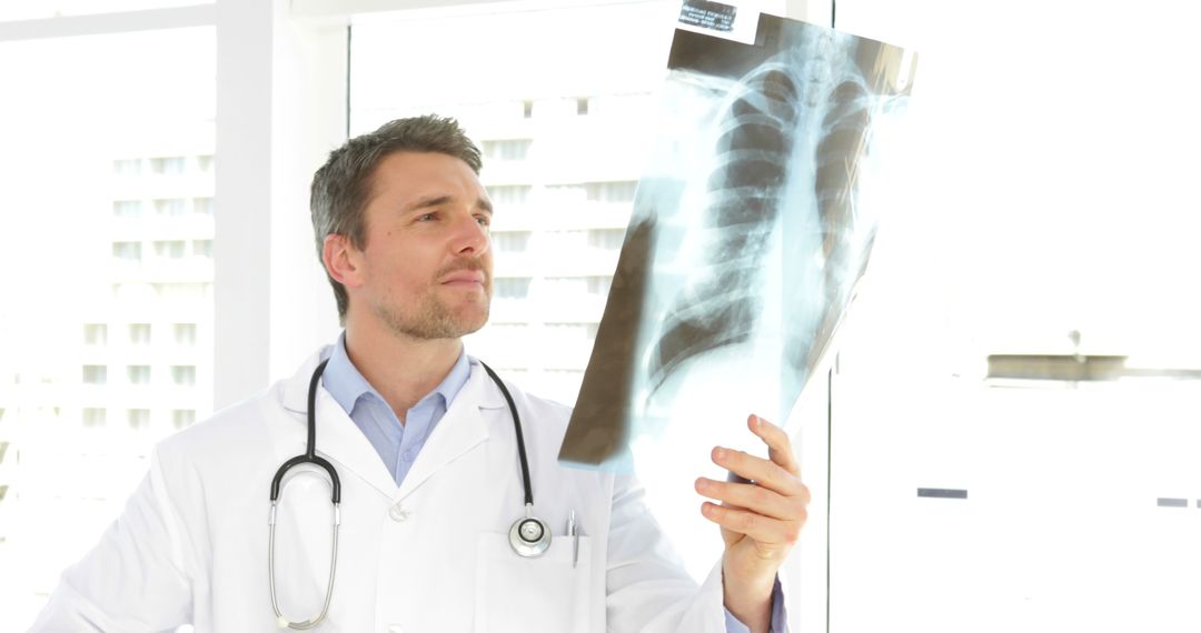 Doctor Examining Chest X-Ray in Bright Medical Office - Free Images, Stock Photos and Pictures on Pikwizard.com