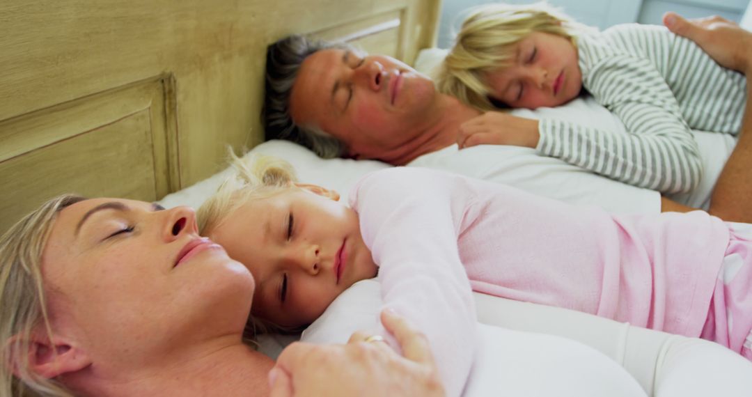 Family Sleeping Together in Bed Relaxing - Free Images, Stock Photos and Pictures on Pikwizard.com