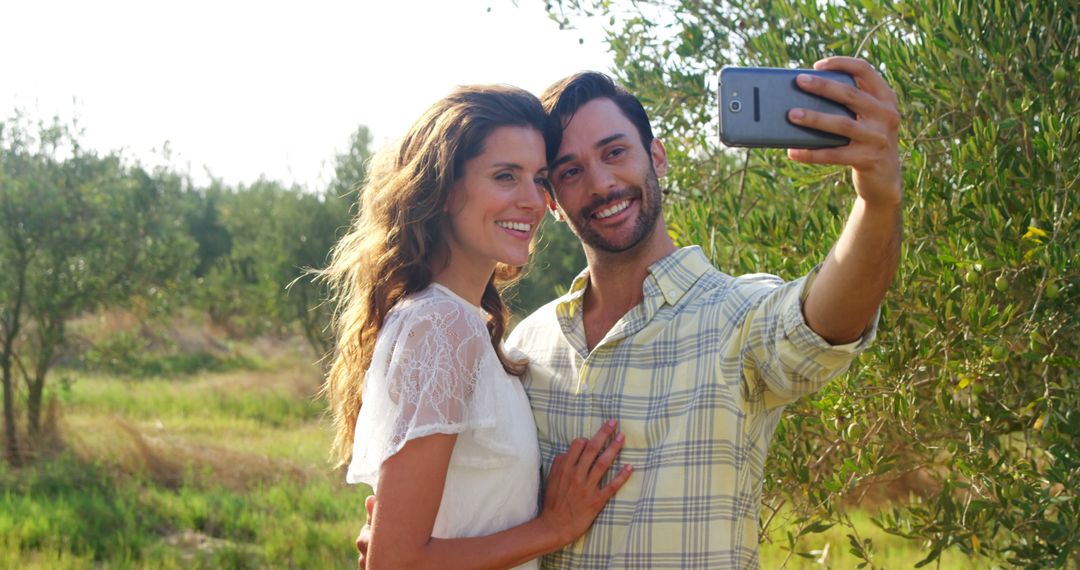 Joyful Couple Taking Selfie in Vibrant Nature Setting