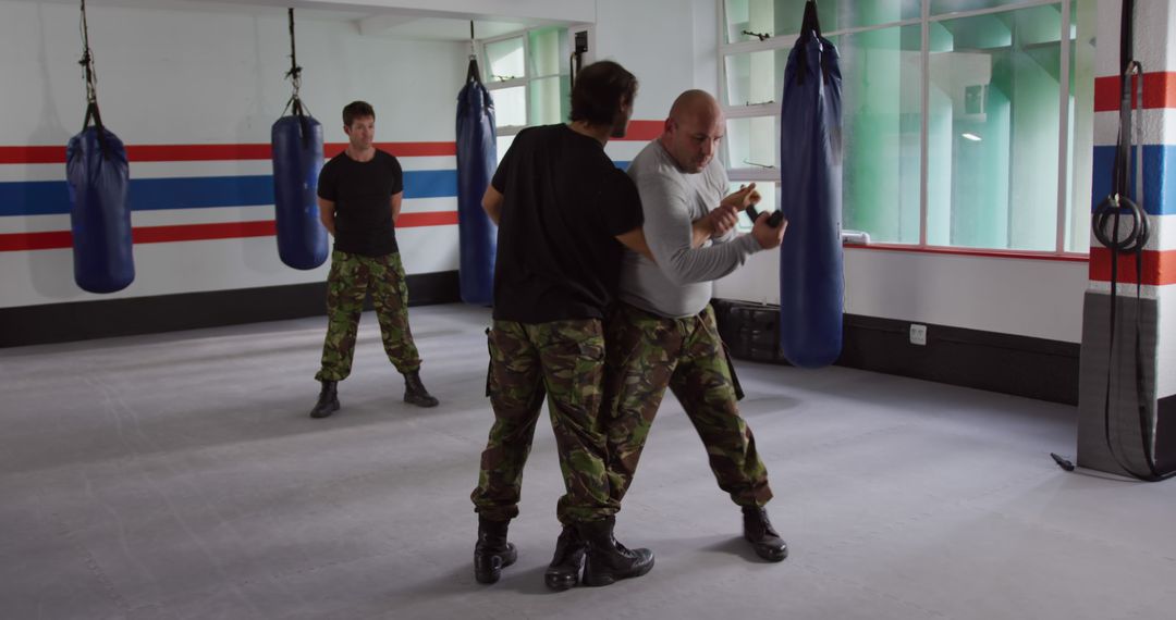 Army Instructor Training with Soldiers in Gym Combat Class