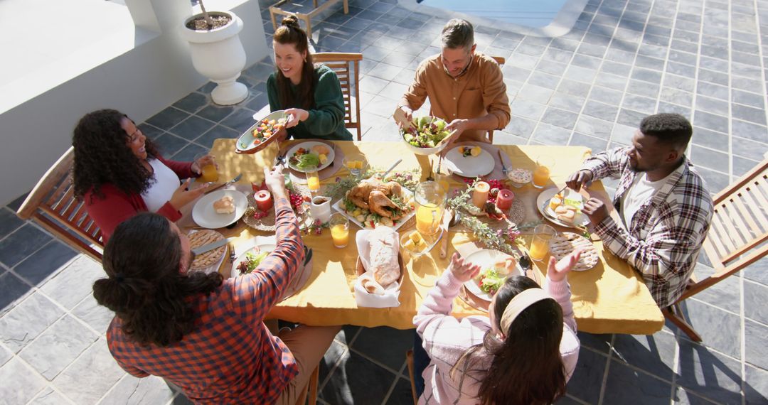 Diverse Group Enjoying Outdoor Thanksgiving Feast - Free Images, Stock Photos and Pictures on Pikwizard.com