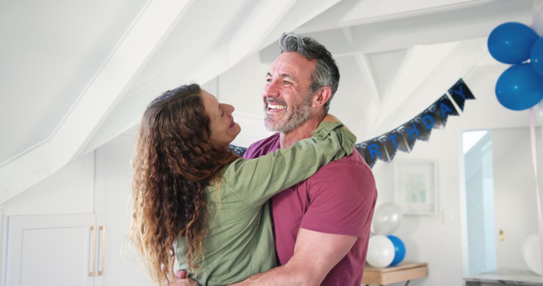 Happy Couple Celebrating Birthday with Joy and Dance at Home