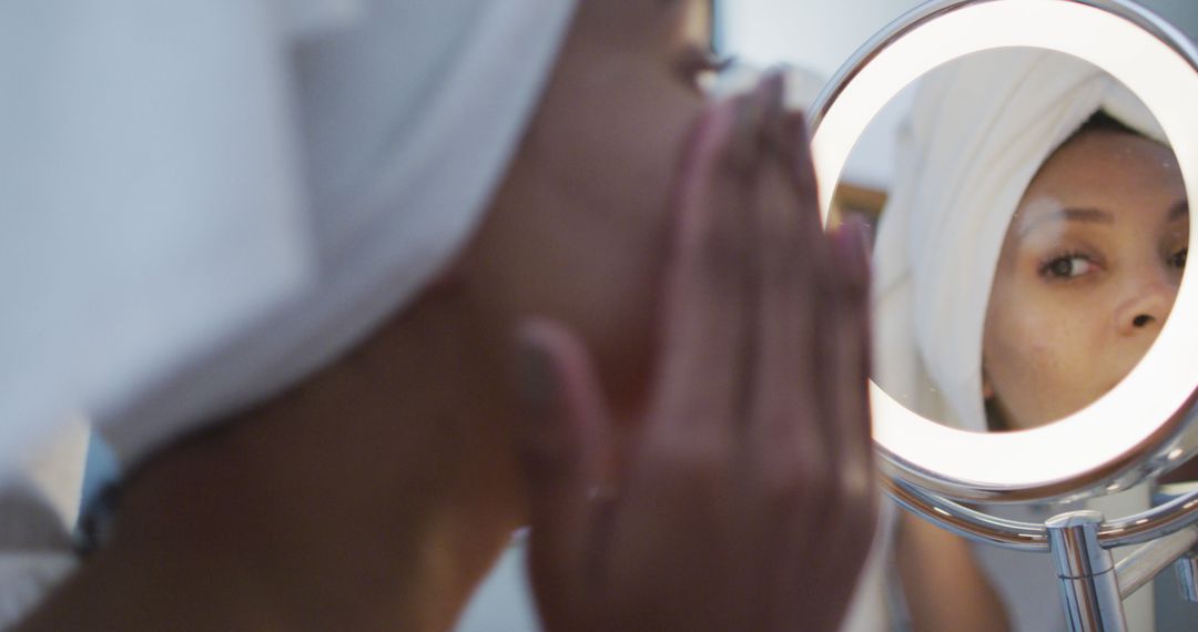 Woman in Towel Reflecting in Mirror - Free Images, Stock Photos and Pictures on Pikwizard.com