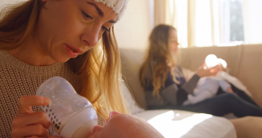 Mother Feeding Baby with Bottle in Cozy Living Room - Free Images, Stock Photos and Pictures on Pikwizard.com