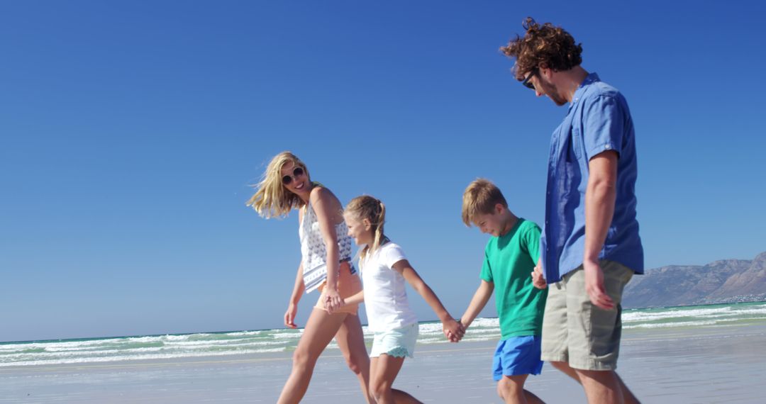 Happy Family Walking on Beach in Summer - Free Images, Stock Photos and Pictures on Pikwizard.com