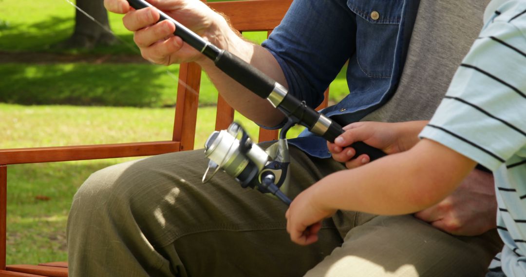 Father Teaching Son How to Fish in Park - Free Images, Stock Photos and Pictures on Pikwizard.com