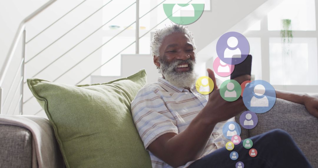 Senior Man Joyfully Engaged with Social Media on Smartphone