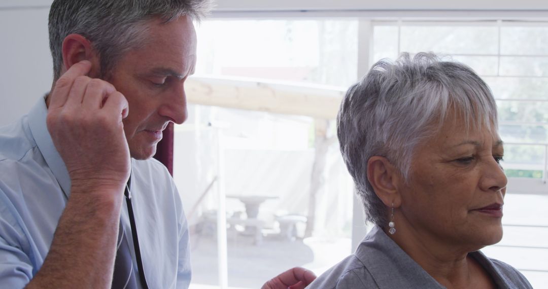 Doctor Examines Senior Patient with Stethoscope in Retirement Home