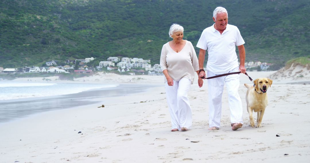 Senior Couple Enjoying Leisurely Beach Walk with Pet Dog - Free Images, Stock Photos and Pictures on Pikwizard.com