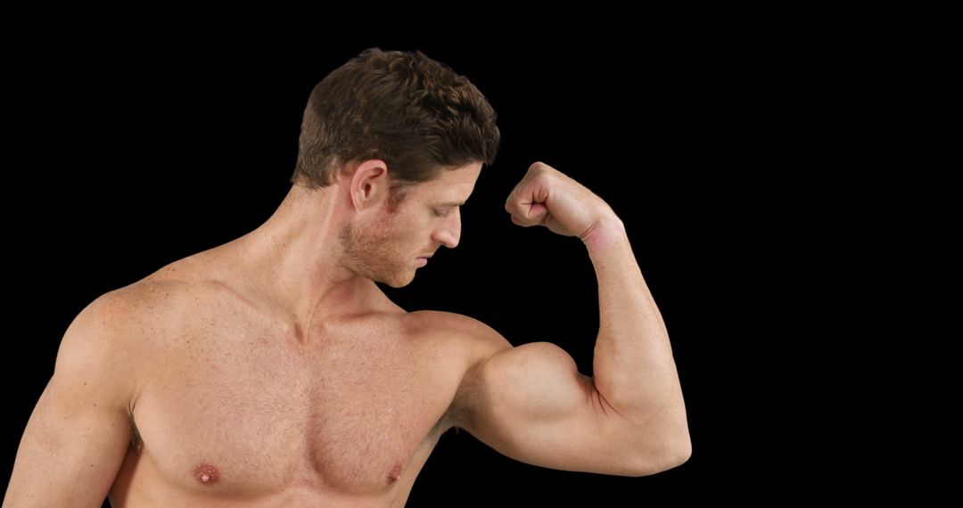 A muscular young man poses to highlight his fitness and strength on a black backdrop. - Free Images, Stock Photos and Pictures on Pikwizard.com