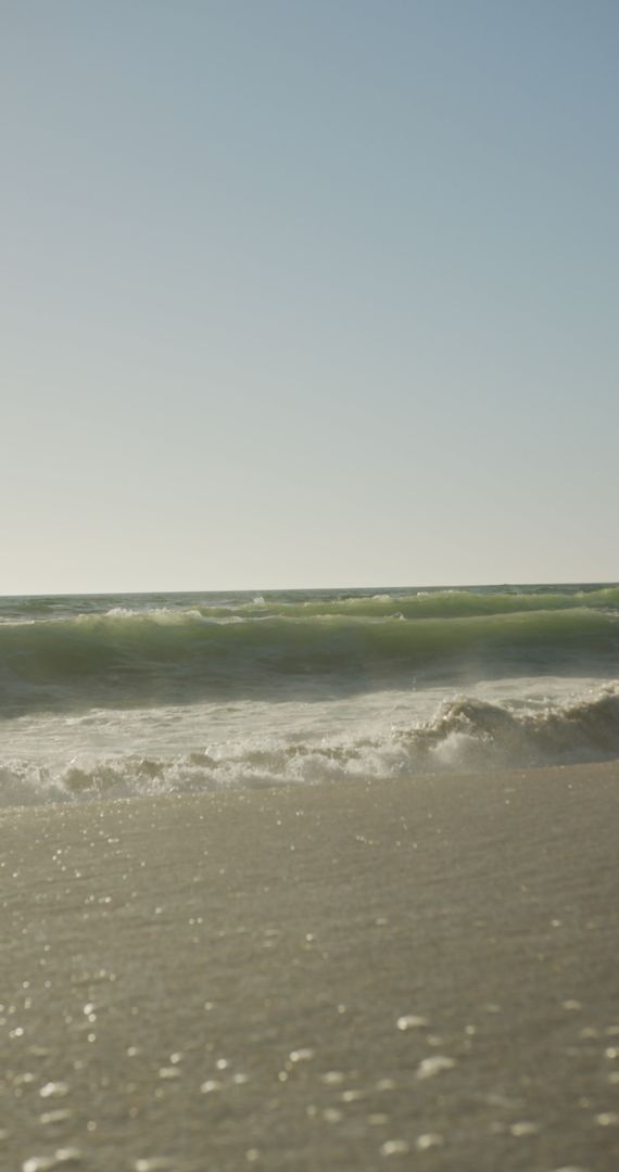 Serene Beach Waves Under Clear Sky