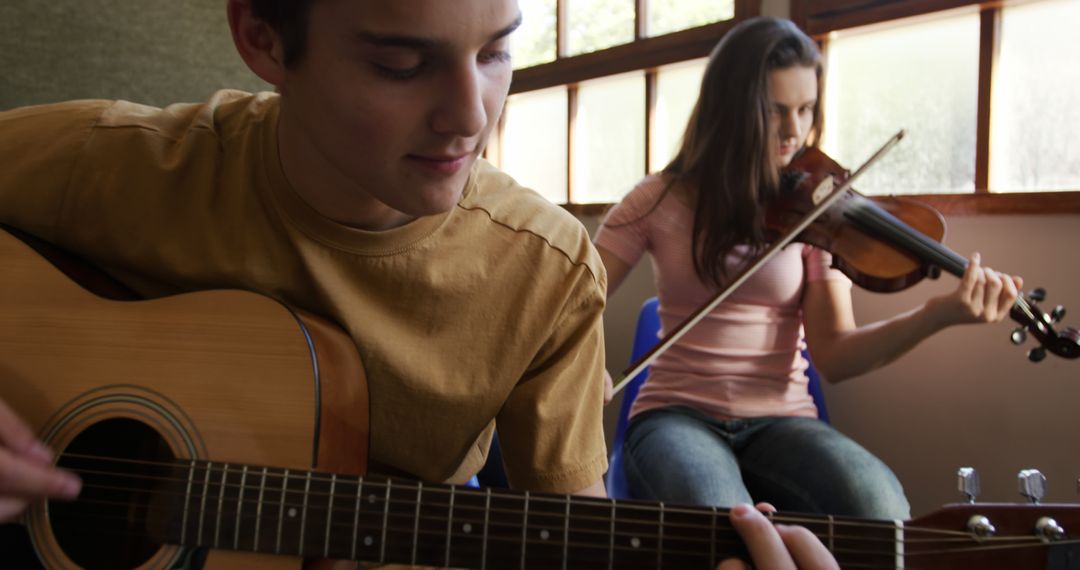 Two Teens Playing Musical Instruments in a Classroom Setting - Free Images, Stock Photos and Pictures on Pikwizard.com