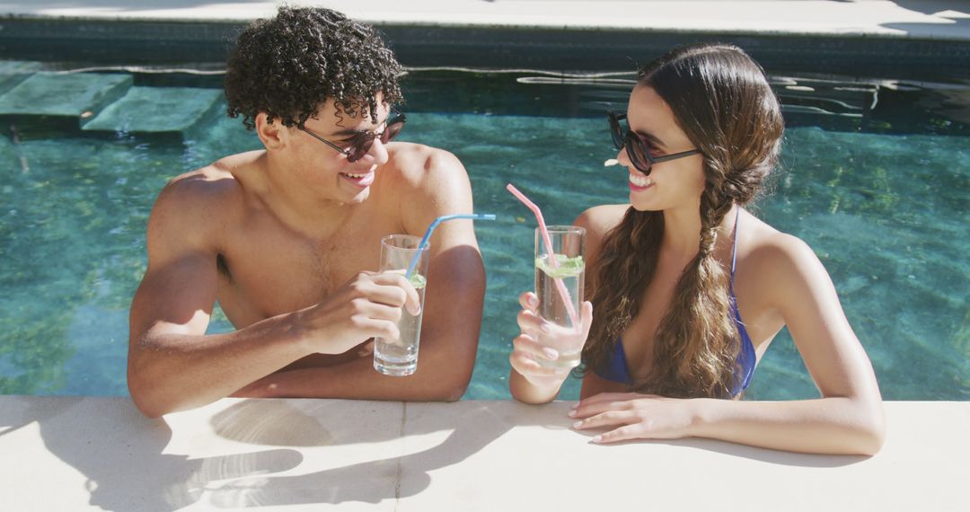 Young Couple Enjoying Refreshing Drinks in Swimming Pool - Free Images, Stock Photos and Pictures on Pikwizard.com