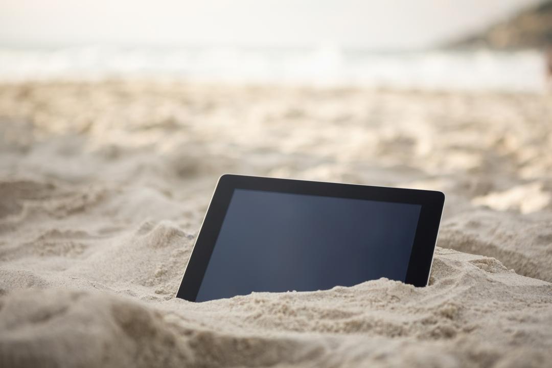 Digital Tablet Buried in Sand at Beach - Free Images, Stock Photos and Pictures on Pikwizard.com
