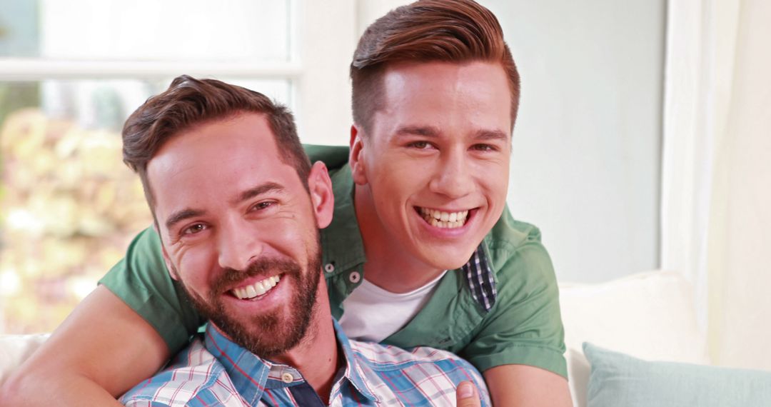 Two Happy Men Smiling and Celebrating Close Friendship at Home