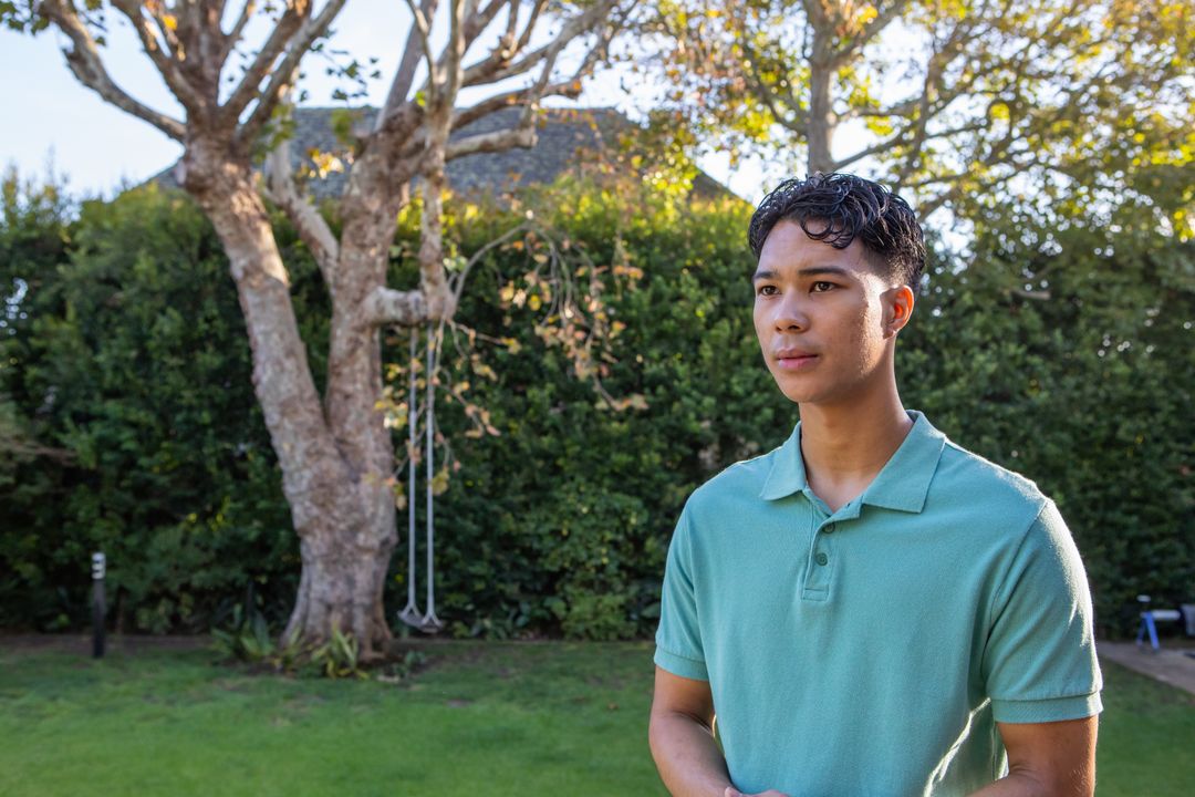 Contemplative Man Enjoying Tranquil Backyard on a Sunny Day