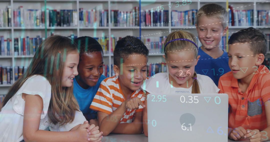 Elementary students collaborating on laptop in school library for digital learning