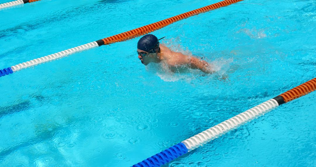 Competitive Male Swimmer Racing in Pool Lane - Free Images, Stock Photos and Pictures on Pikwizard.com