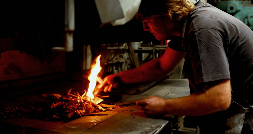 Man Igniting Fire in Workshop for Metalworking - Free Images, Stock Photos and Pictures on Pikwizard.com