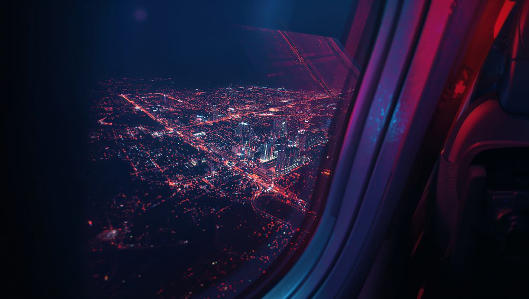 Vibrant Cityscape View through Airplane Window at Night
