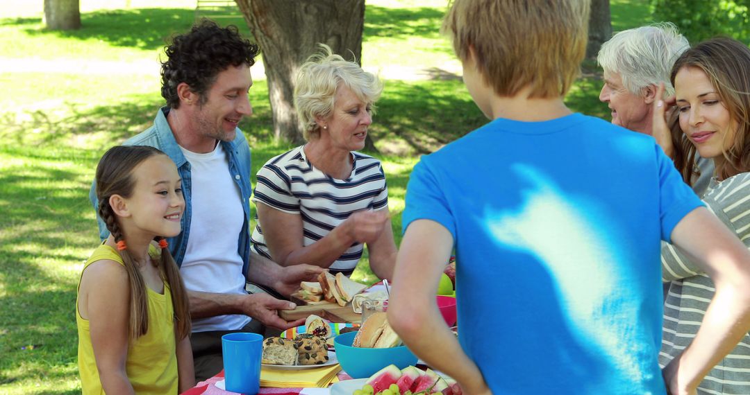 Family Enjoying Outdoor Picnic in Park - Free Images, Stock Photos and Pictures on Pikwizard.com