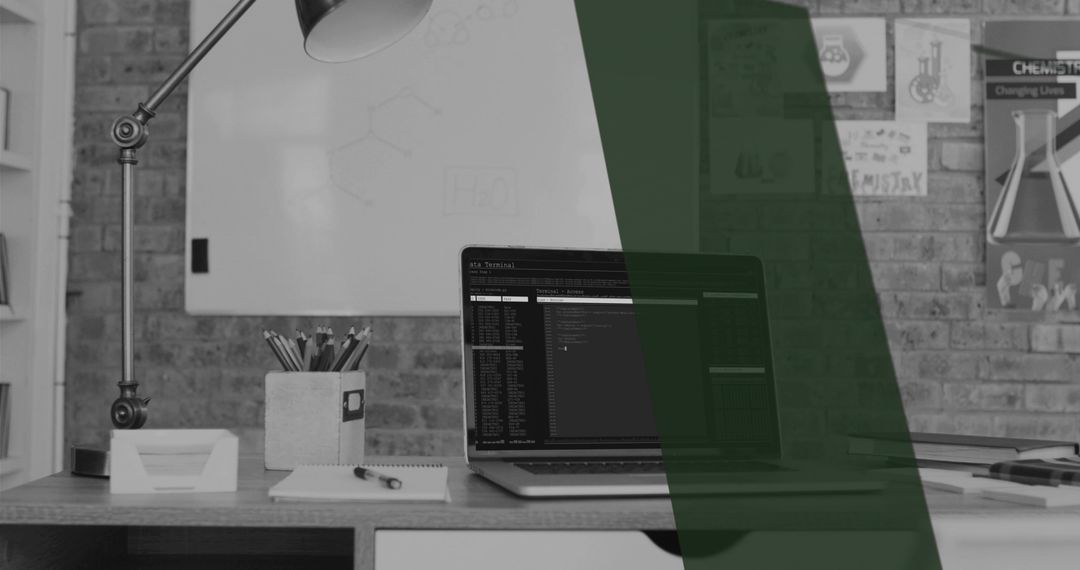 Modern Office Workspace with Laptop Displaying Data Code