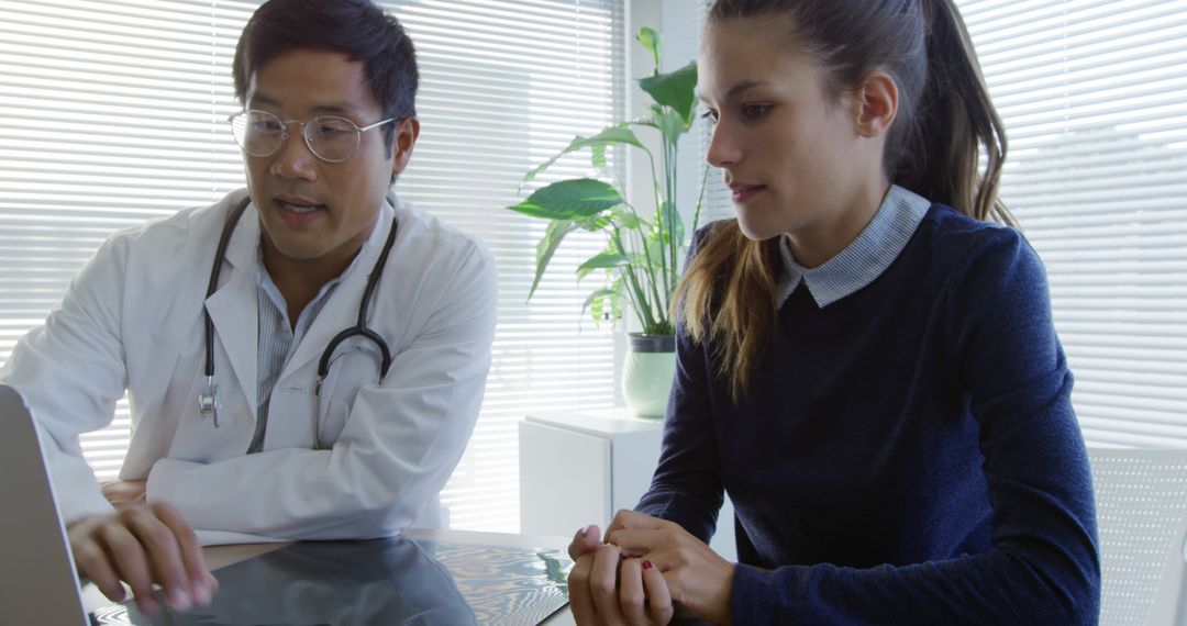 Doctor Consultation with Female Patient Discussing Medical Records - Free Images, Stock Photos and Pictures on Pikwizard.com