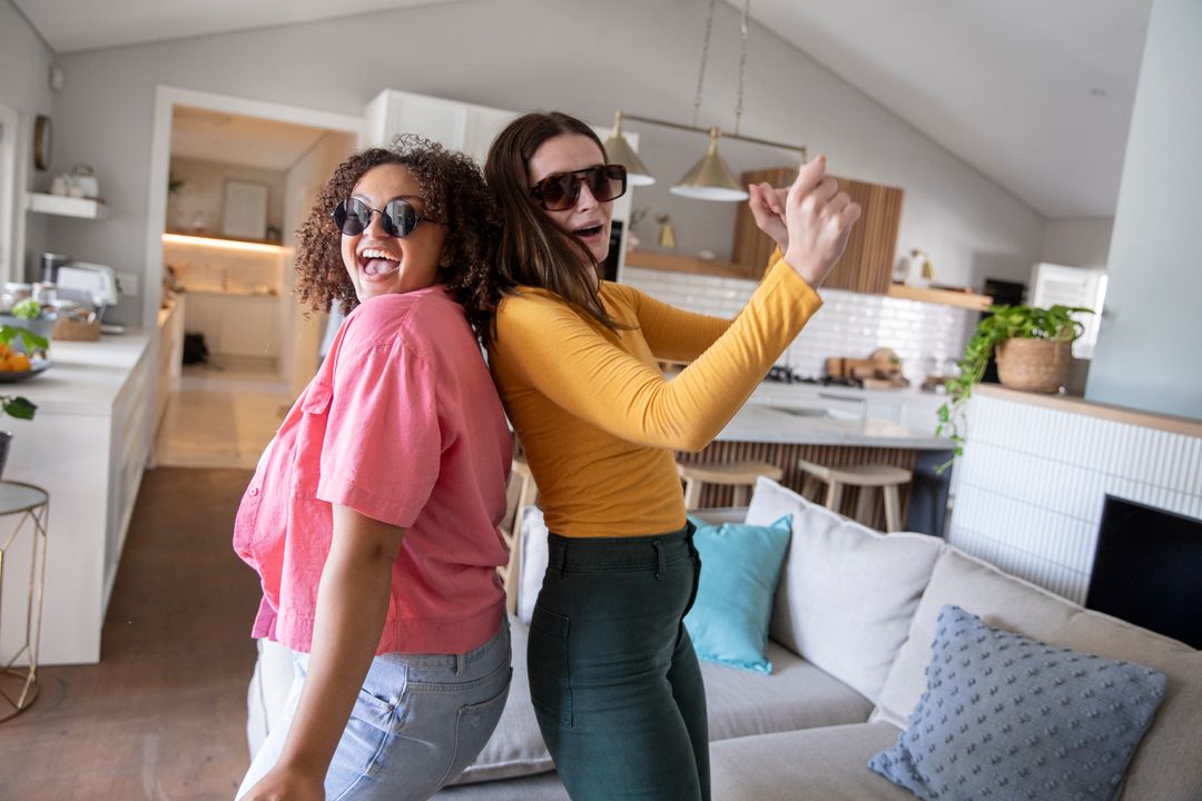 Diverse Friends Dancing Joyfully in Modern Kitchen