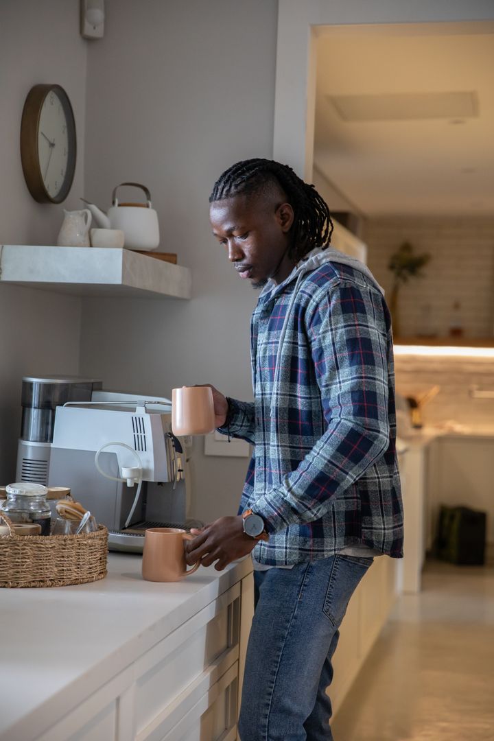 Man Using Espresso Machine in Cozy Modern Kitchen