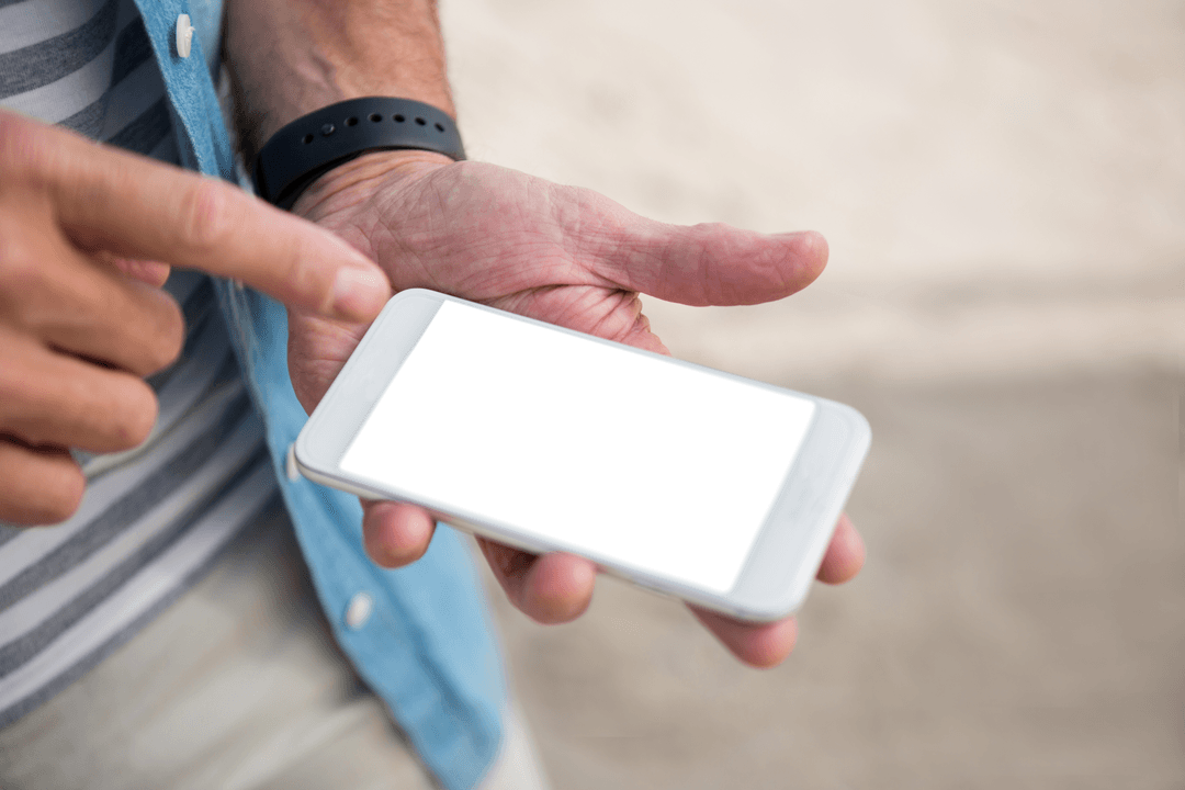 Midsection of Man Using Transparent Smartphone at Beach