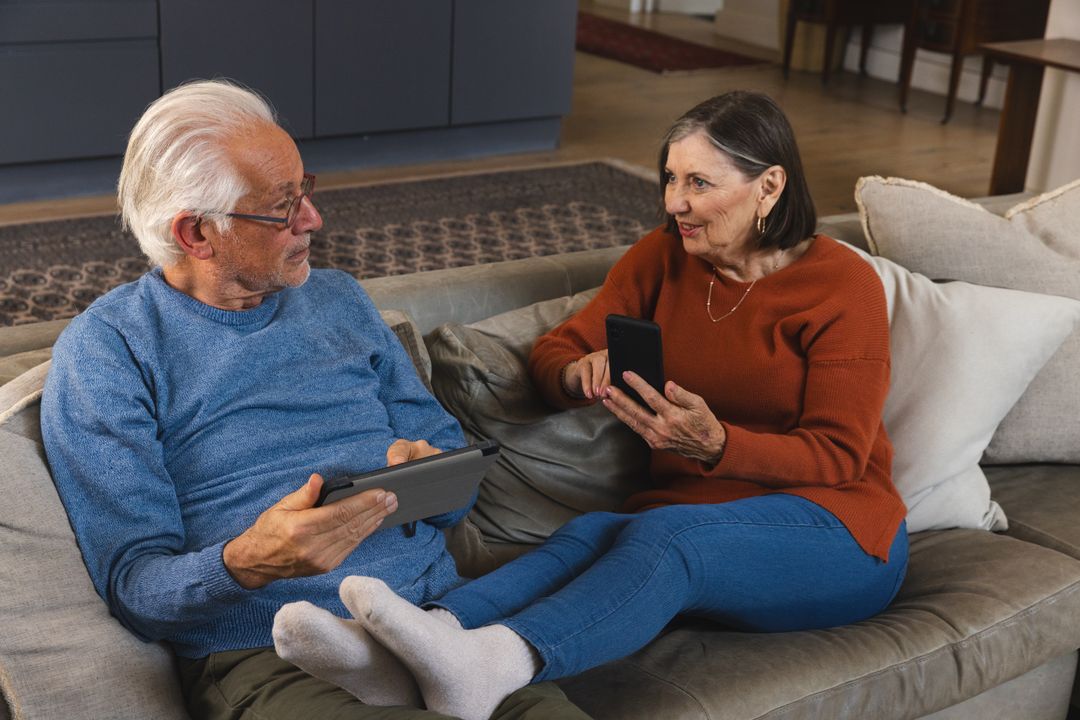 Senior Couple Relaxing with Technology at Home
