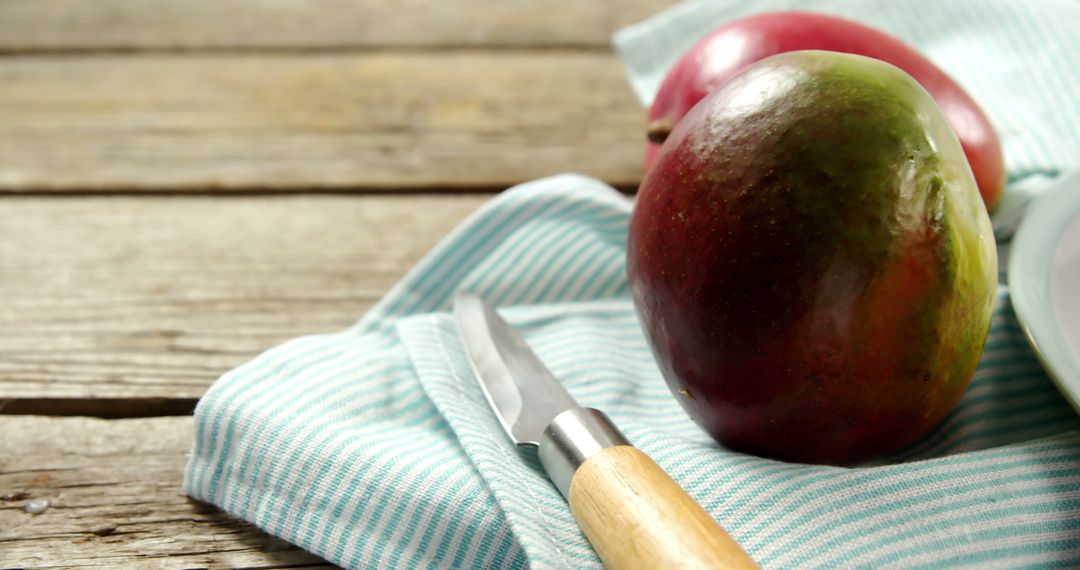 Fresh Mangos with Knife on Wooden Table - Free Images, Stock Photos and Pictures on Pikwizard.com