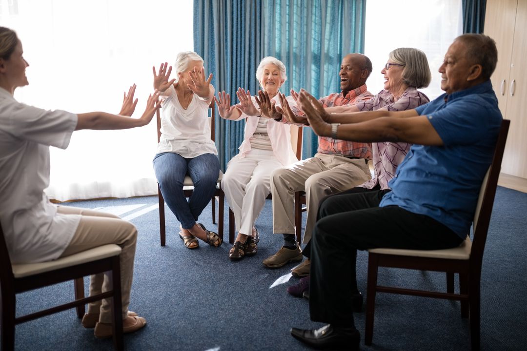 Seniors Exercising with Female Doctor in Retirement Home - Free Images, Stock Photos and Pictures on Pikwizard.com
