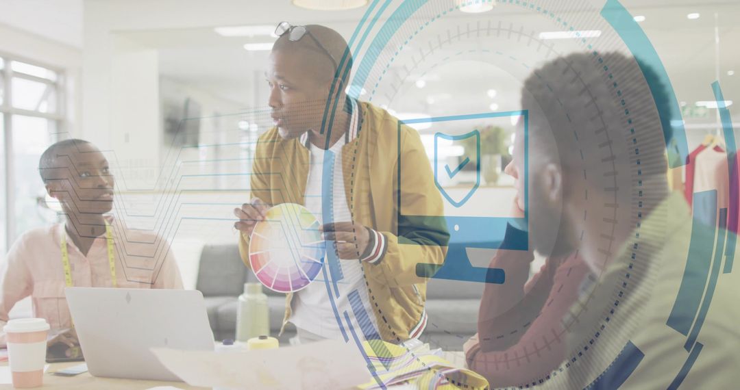 Creative Team Collaborating Over Color Wheel and Fabric Swatches in Modern Design Studio