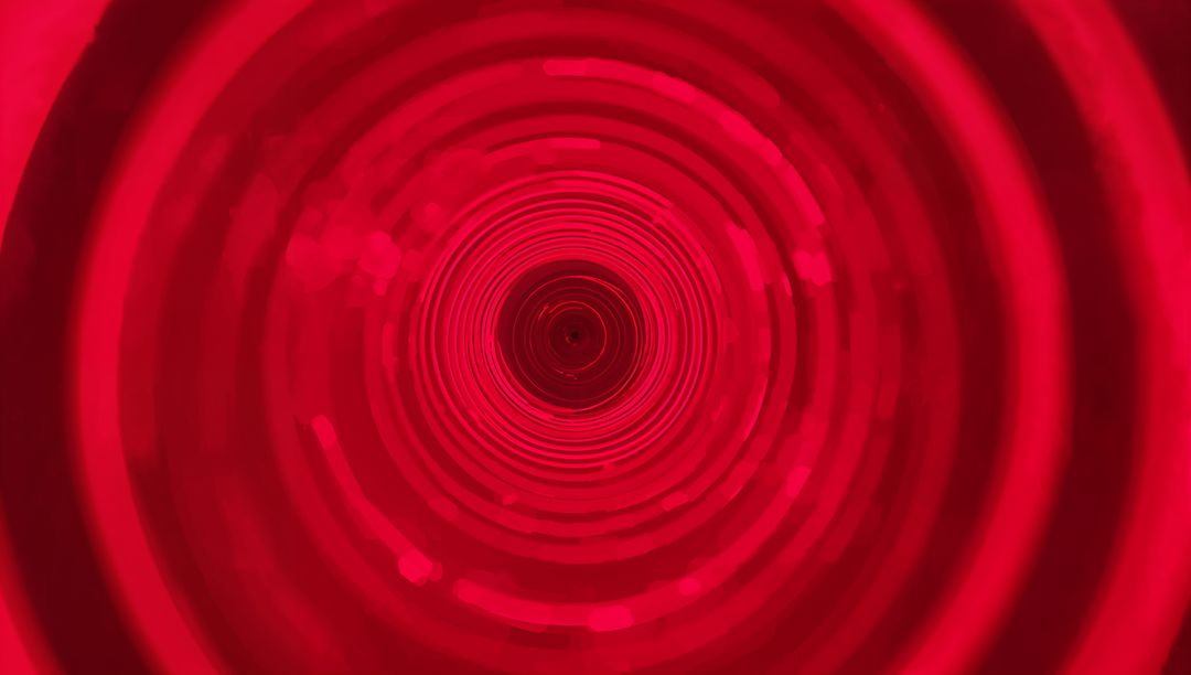 Crimson LED Tunnel Drawing Eye into Concentric Light Rings and Deep Aperture