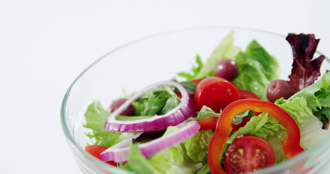 Fresh Vegetable Salad with Lettuce, Cherry Tomatoes, and Onions in Glass Bowl - Free Images, Stock Photos and Pictures on Pikwizard.com